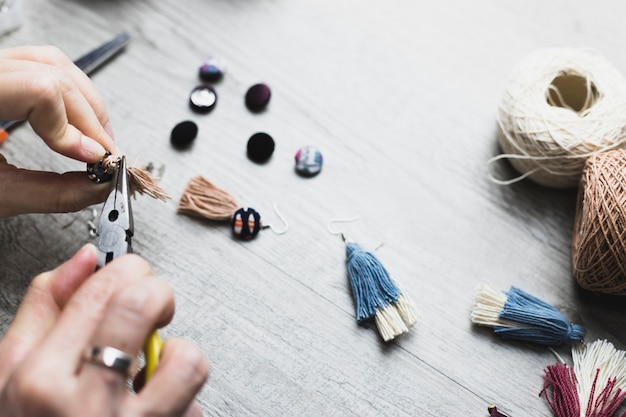 Crop hands making earrings