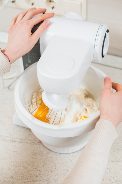 Crop hands mixing batter for pastry