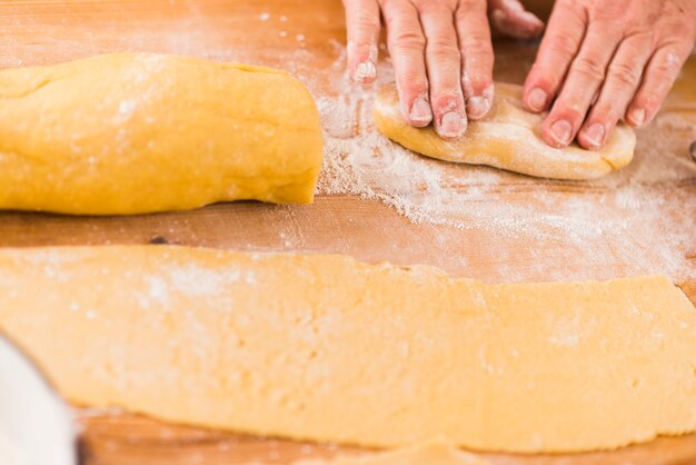 Crop hands preparing dough