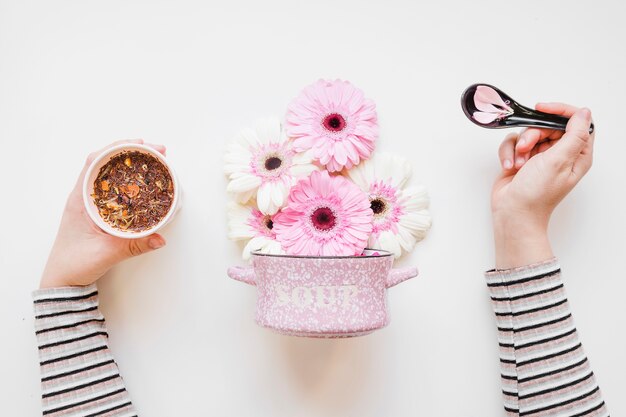 Crop hands preparing flowers