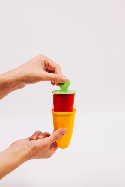 Crop hands taking ice-cream out of mold