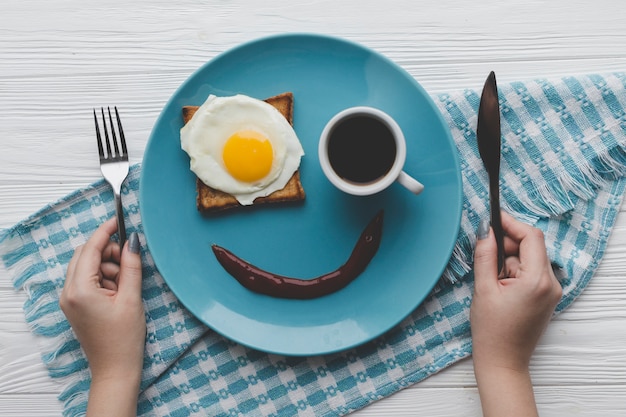 Crop hands with cutlery near food