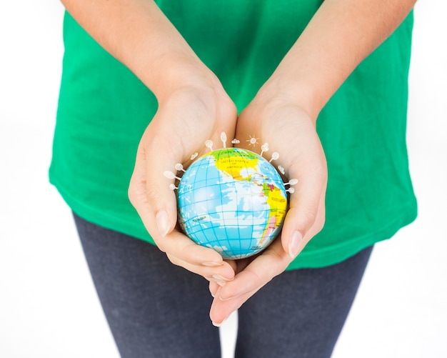 Free photo crop hands of woman holding globe