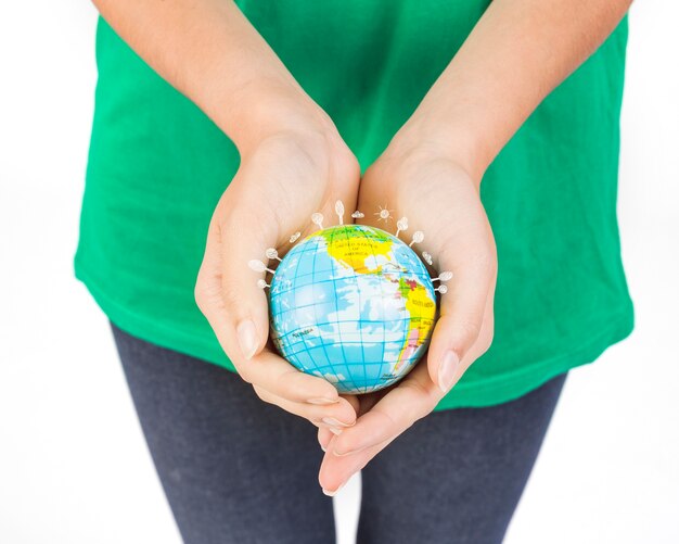 Crop hands of woman holding globe