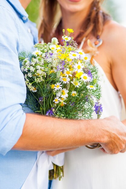 The crop image of romantic couple with flowers