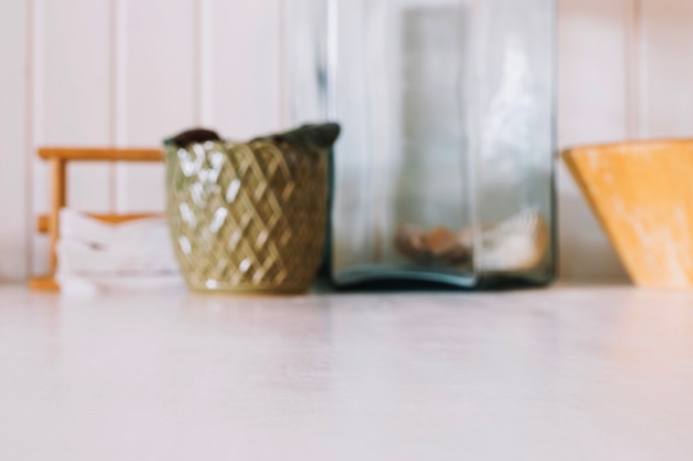 Crop kitchenware on white table