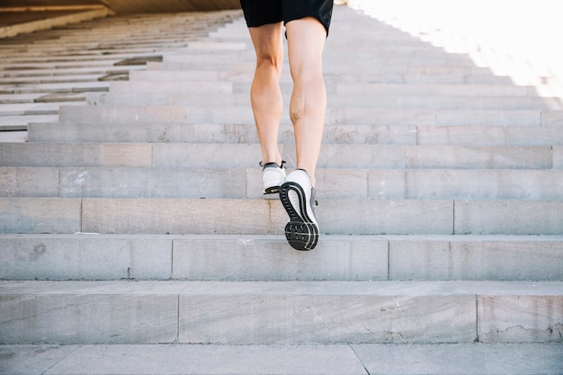 Free photo crop legs leaping upstairs