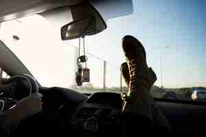 Free photo crop legs near windscreen in car