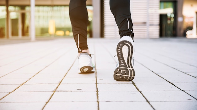 Crop legs running on street