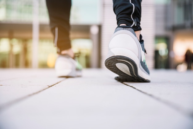 Free photo crop legs sprinting on street