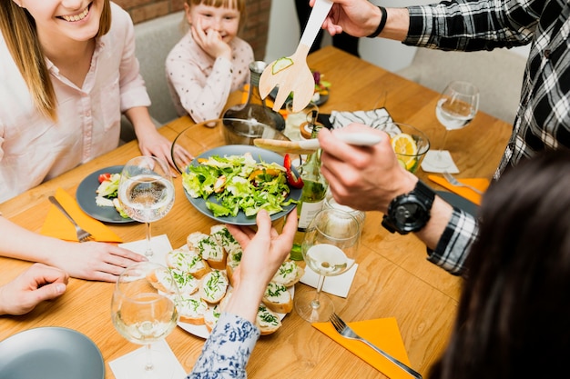 Crop male hands putting delicious dish