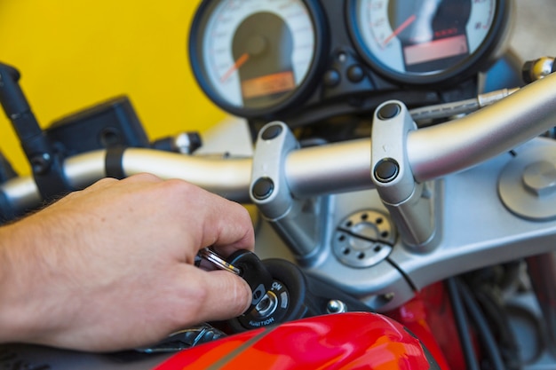 Free photo crop man firing up motorcycle