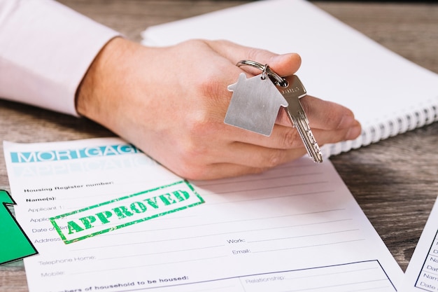 Free photo crop man giving new house key