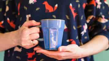 Free photo crop man holding blue mug