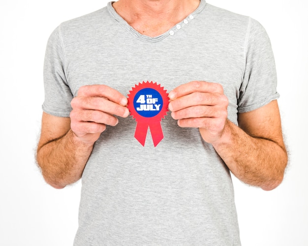 Free photo crop man holding independence day badge