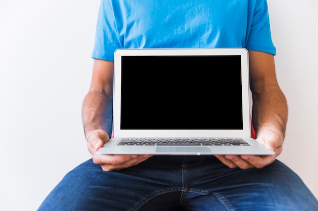 Free photo crop man holding modern laptop