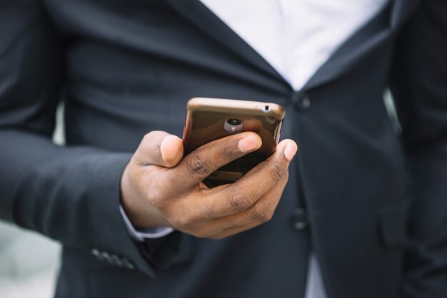 Crop man holding smartphone