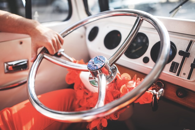 Free photo crop man holding steering wheel