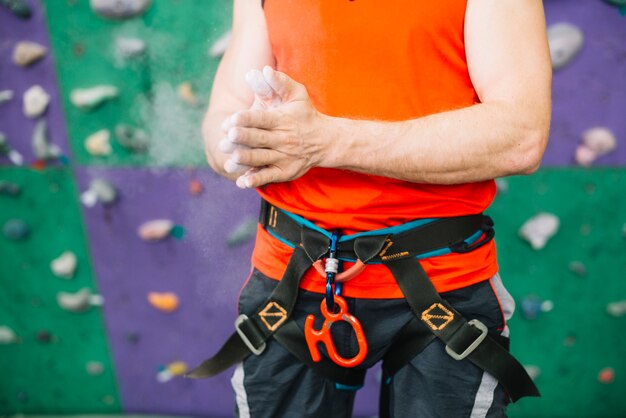 Crop man near climbing wall