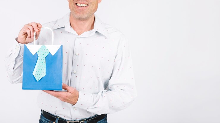 Free Photo crop man showing gift