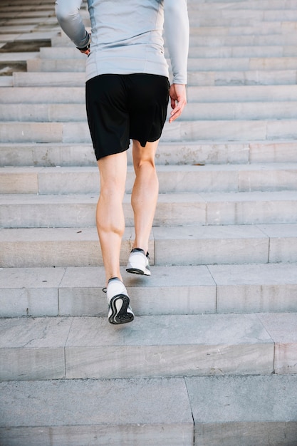 Free photo crop man on staircase workout