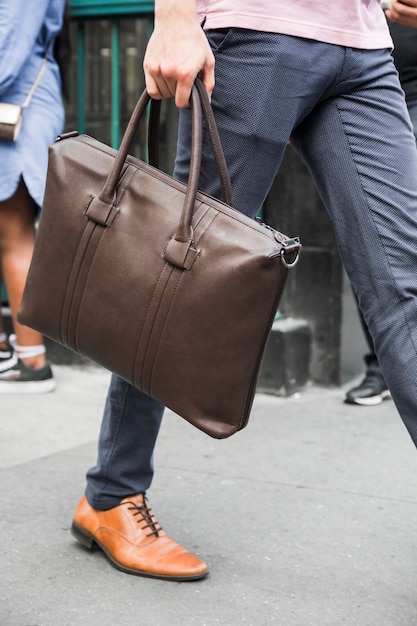 Free photo crop man with bag going to walk