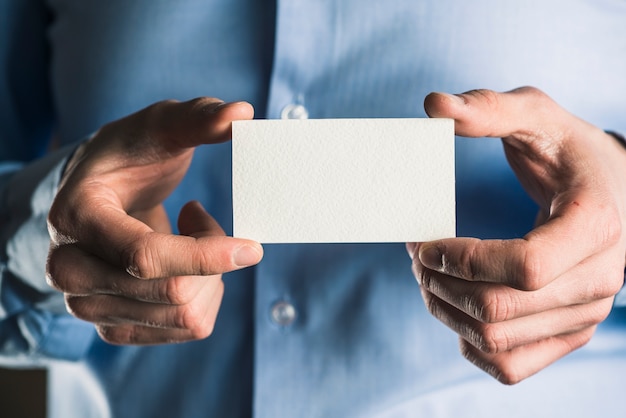 Crop man with business card