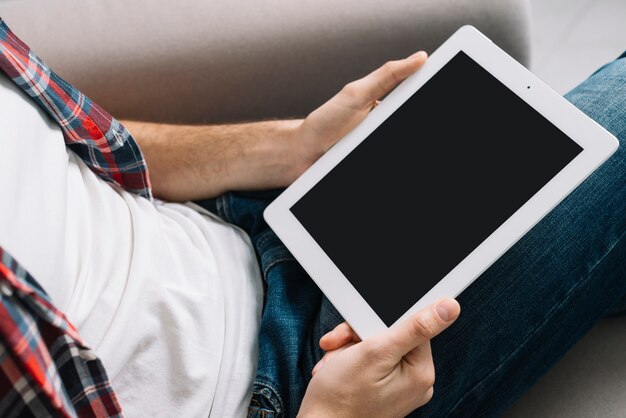 Crop man with tablet