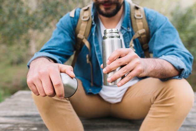 Crop man with thermos