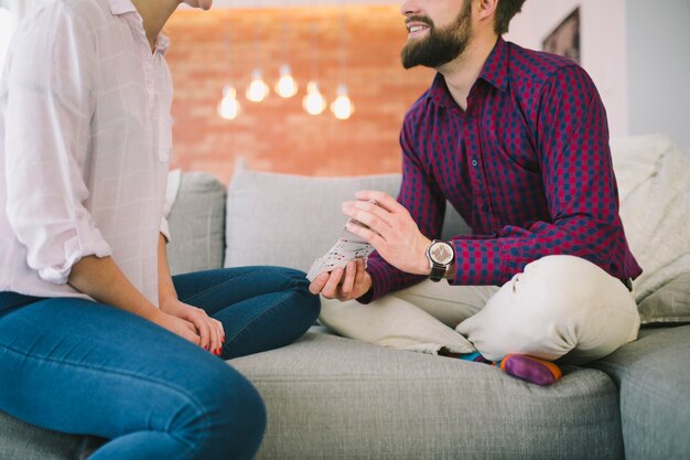 Crop man and woman playing cards