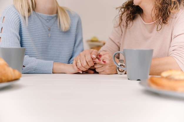 Ritaglia la madre e la figlia tenendosi per mano