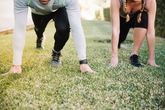 Crop people standing in start position