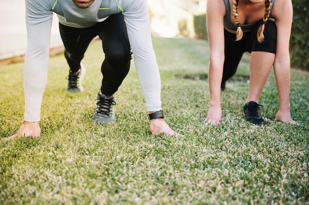 Crop people standing in start position