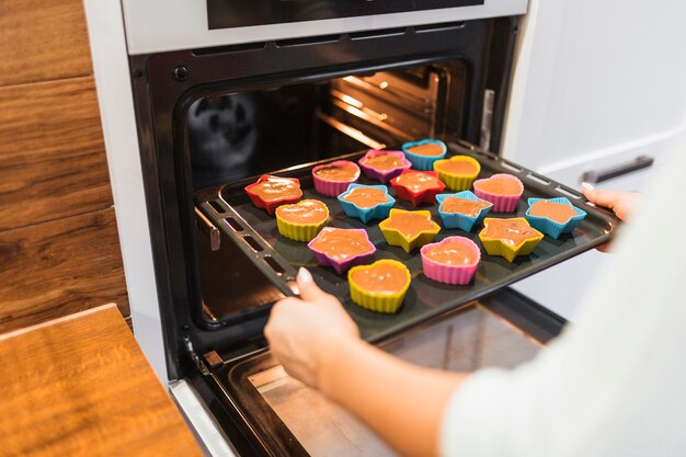 Crop person baking cupcakes