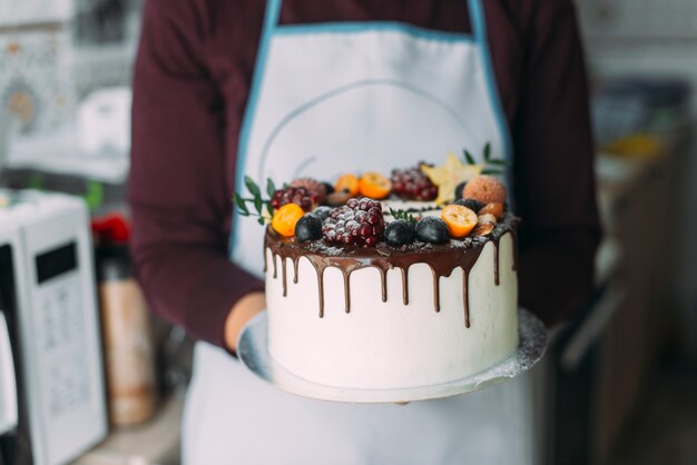 Crop person holding cake