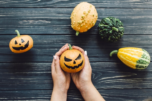 Crop person holding Halloween pumpkin