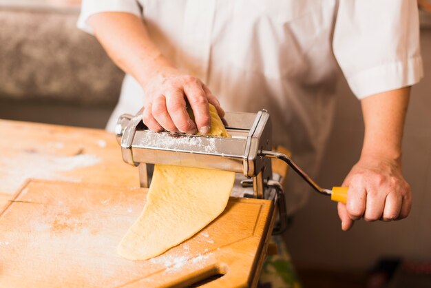 Crop person making pasta