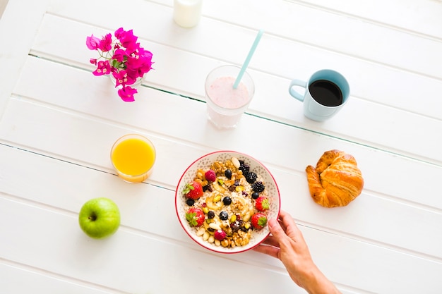 Crop person serving healthy breakfast