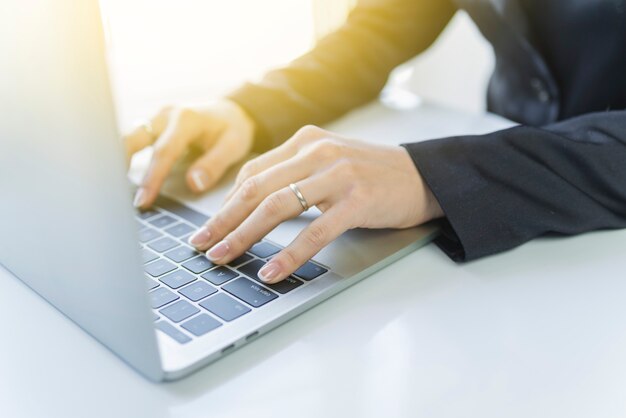 Crop person working on laptop