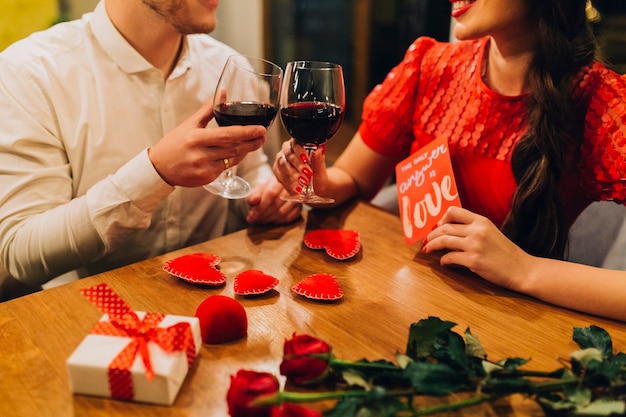 Crop romantic people having date in restaurant