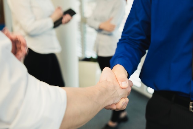 Free photo crop shot of men shaking hands