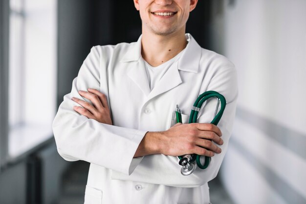 Crop smiling doctor with stethoscope