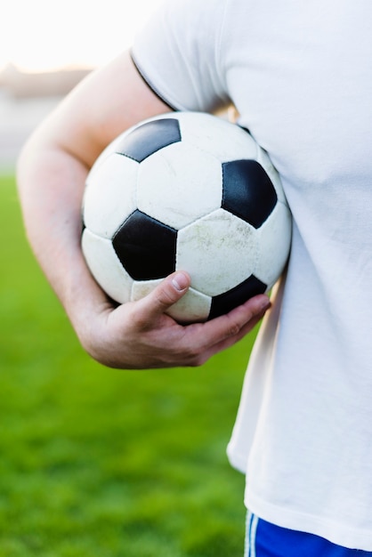 Free photo crop sportsman holding ball