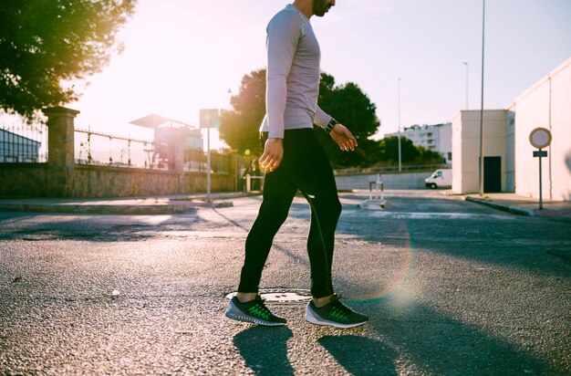 crop sportsman walking on street