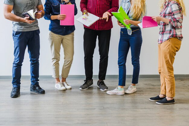 Crop students with notebooks