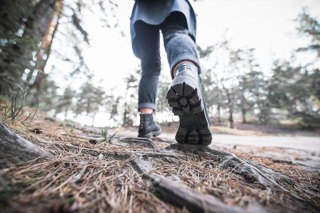 Crop tourist walking in forest