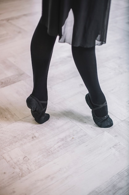 Free photo crop woman dancing on parquet floor