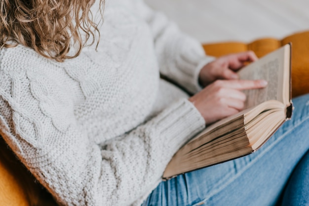 Free photo crop woman enjoying reading