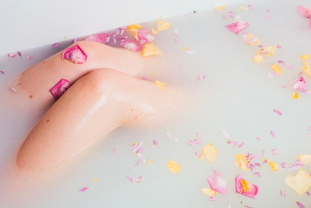 Crop woman enjoying time in bathtub