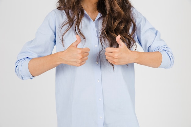 Ritaglia la donna che gesturing pollice in su